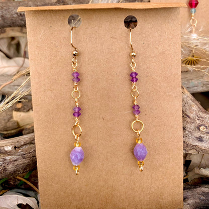 Purple HazeMaterial info: Gemstone dangle earrings Gemstone beads: Amethyst Tiny Faceted Saucer 3x4mm, Lepidolite Faceted Rice 8x6.5-7mm Wire: Tarnish resistant. 22-gauge gold copper Jump rings: 18k gold plated Lepidolite properties: "peace stone" or "gra