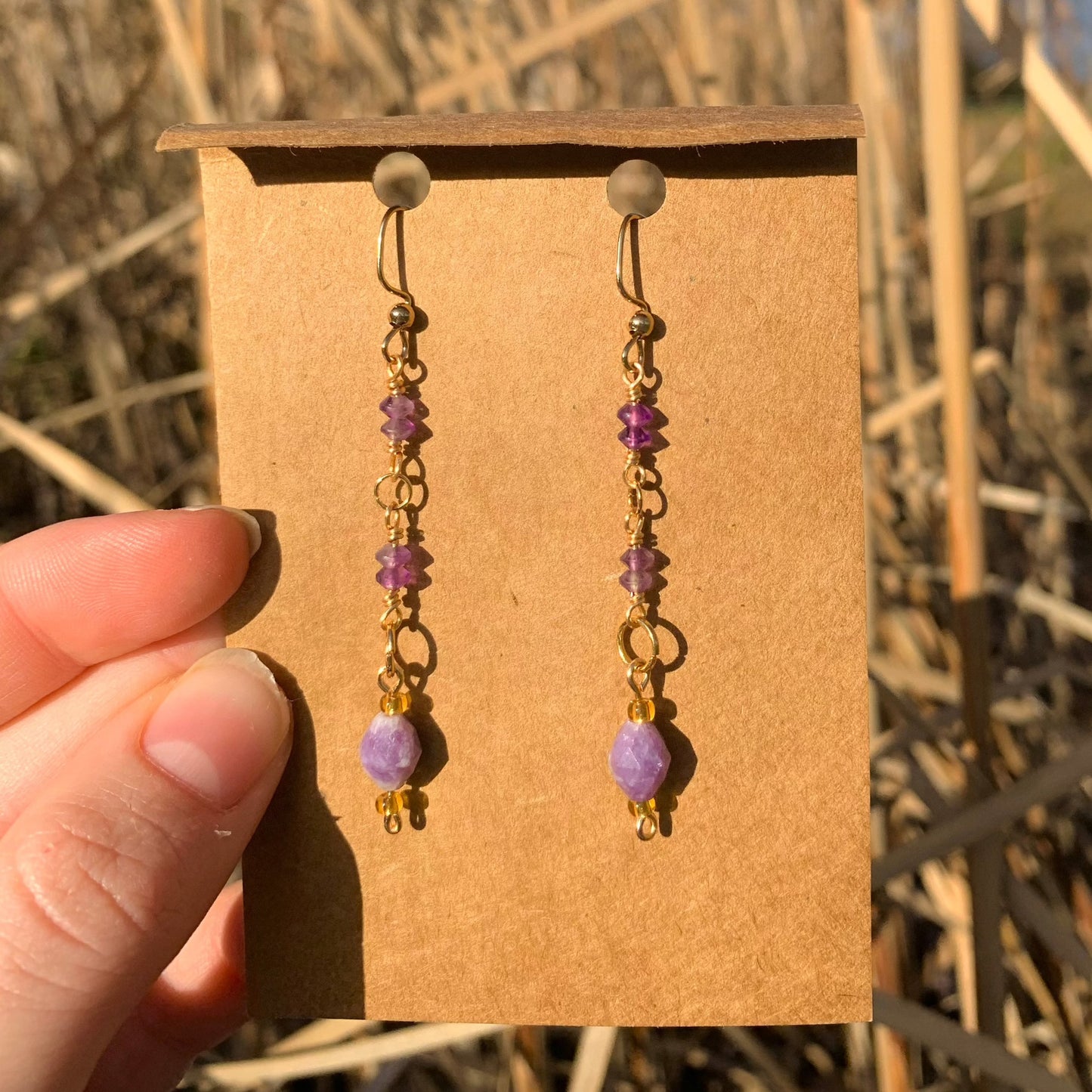 Purple HazeMaterial info: Gemstone dangle earrings Gemstone beads: Amethyst Tiny Faceted Saucer 3x4mm, Lepidolite Faceted Rice 8x6.5-7mm Wire: Tarnish resistant. 22-gauge gold copper Jump rings: 18k gold plated Lepidolite properties: "peace stone" or "gra