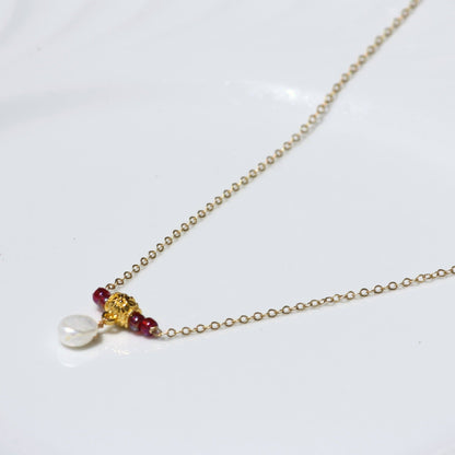 Cherry cove necklace featuring ruby red seed beads and white pearl.