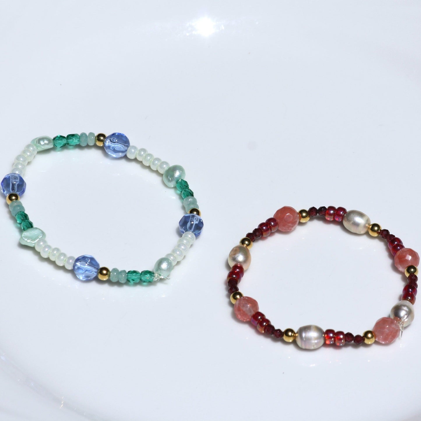 Pink and blue stretch bracelets with pearls and colored beads. 