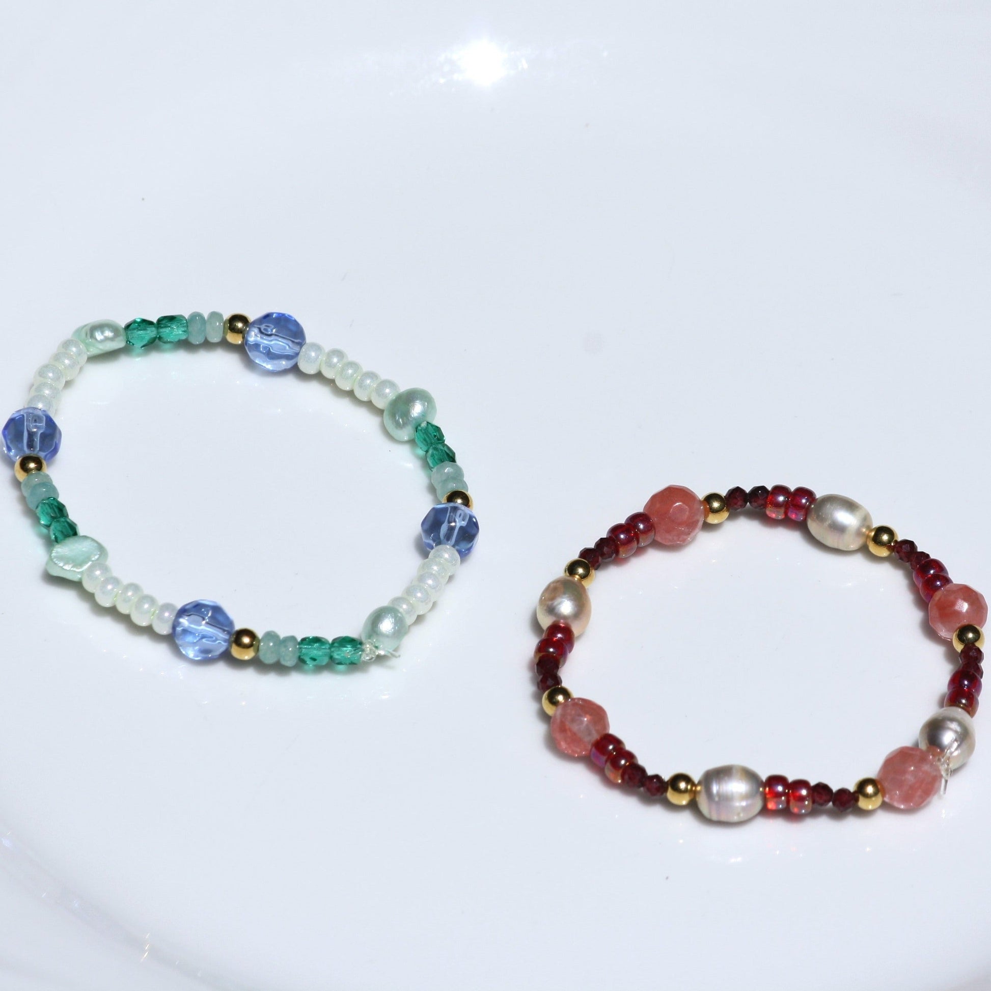 Pink and blue stretch bracelets with pearls and colored beads. 