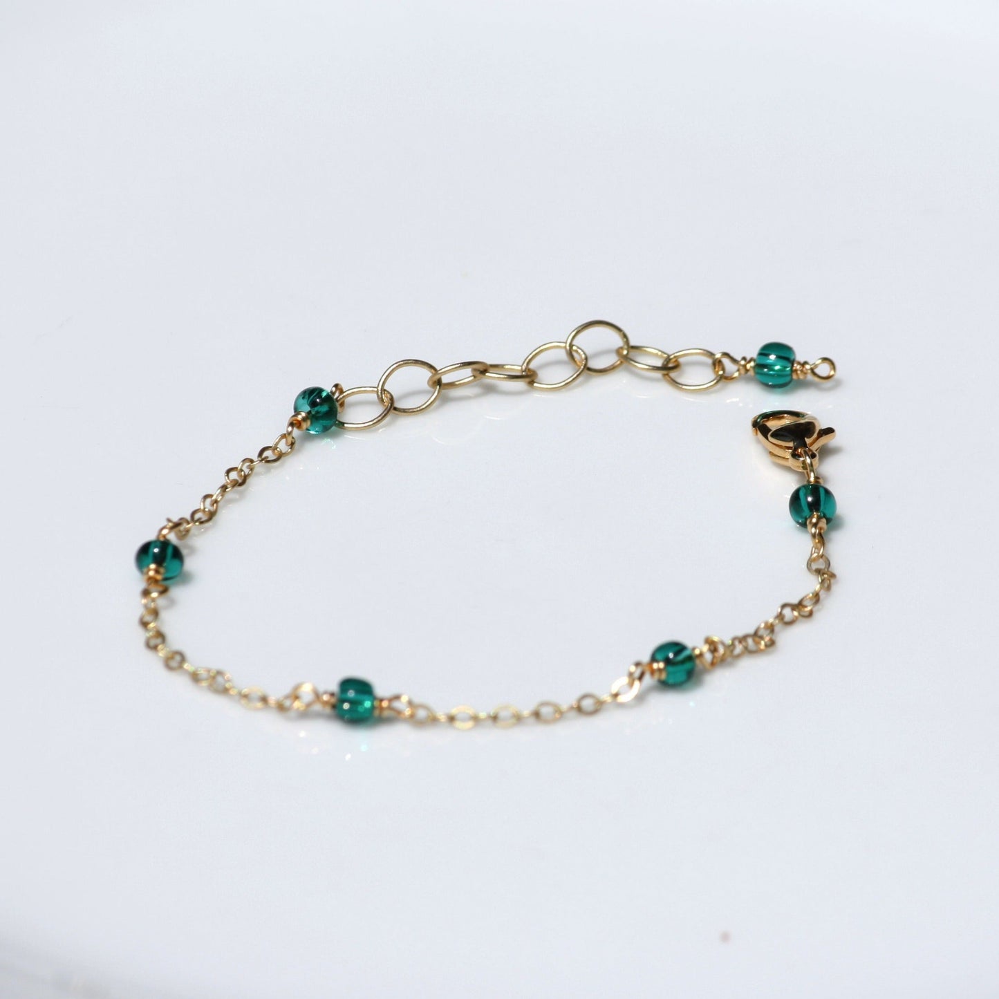 Dainty chain bracelet with teal seed beads. 