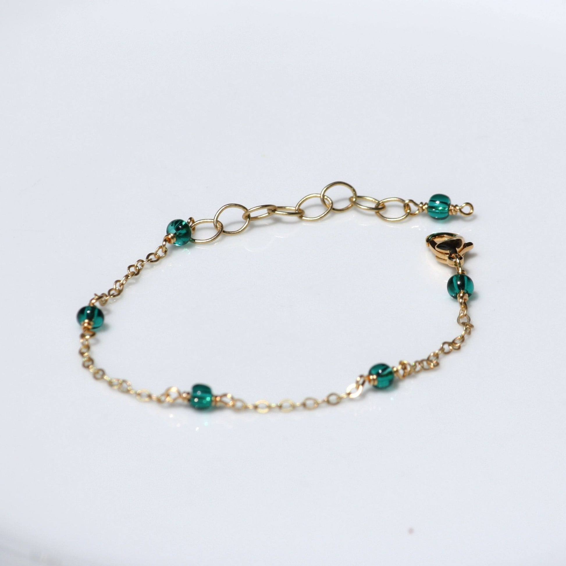 Dainty chain bracelet with teal seed beads. 