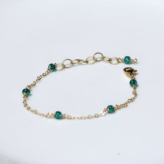 Dainty chain bracelet with teal seed beads. 