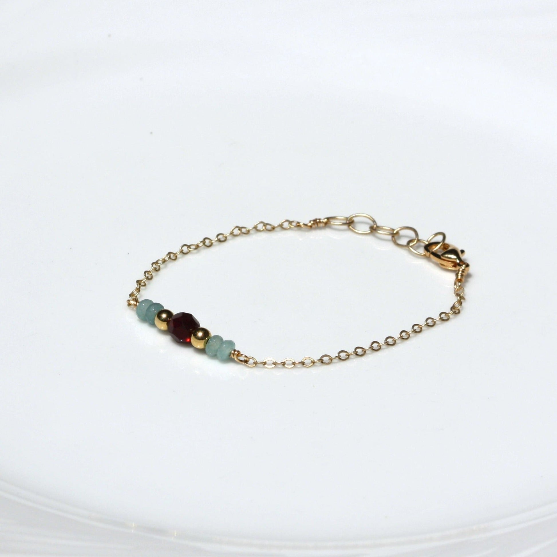 Dainty chain bracelet with garnet bead.