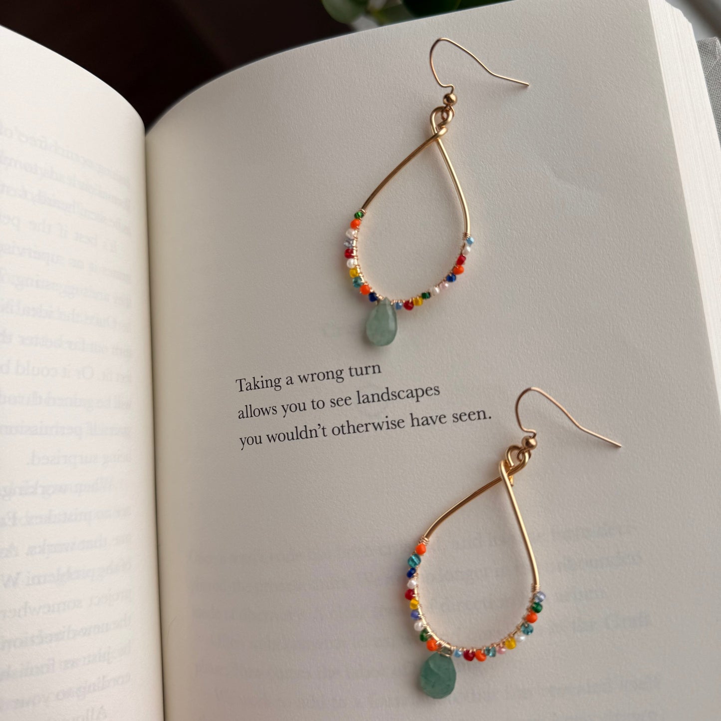 Colorful beaded hoop earrings with green gemstone