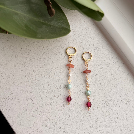 Dangle earrings with blue, pink, orange, and pearl. 