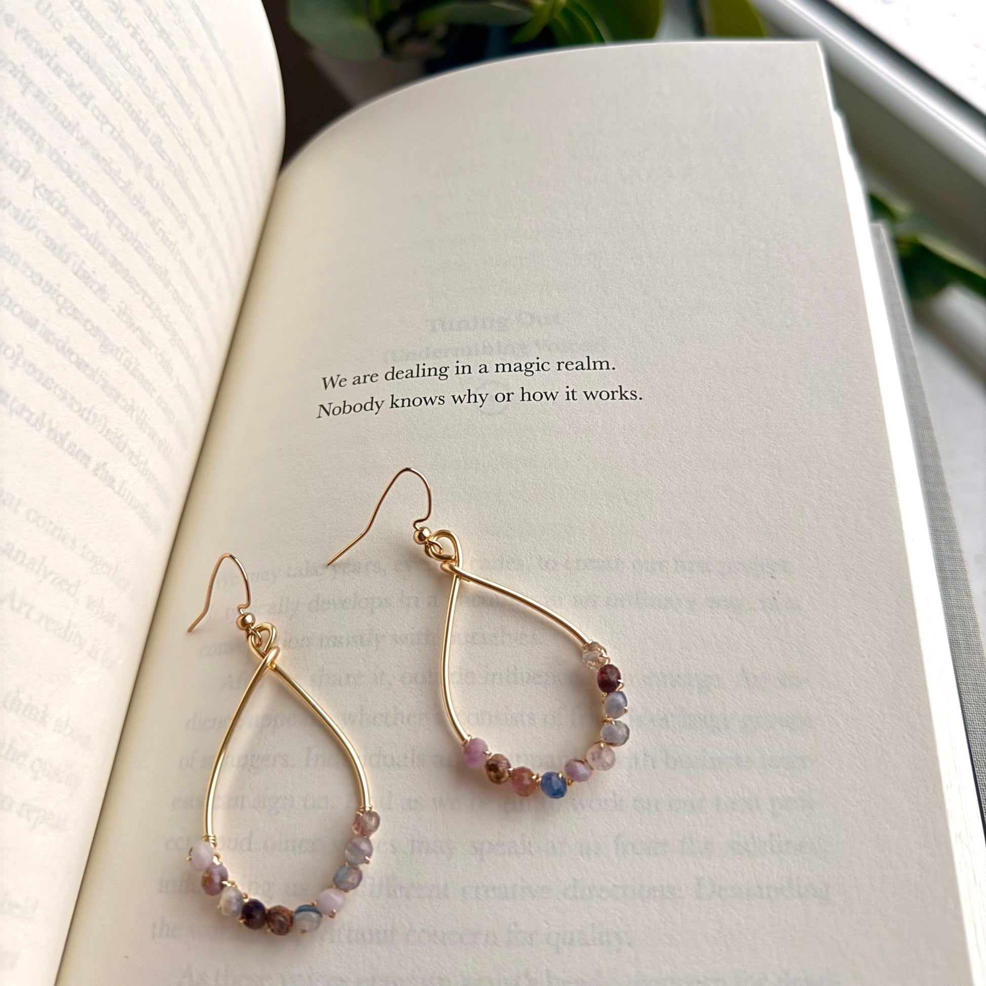 Hoop earrings with mixed purple beads. 