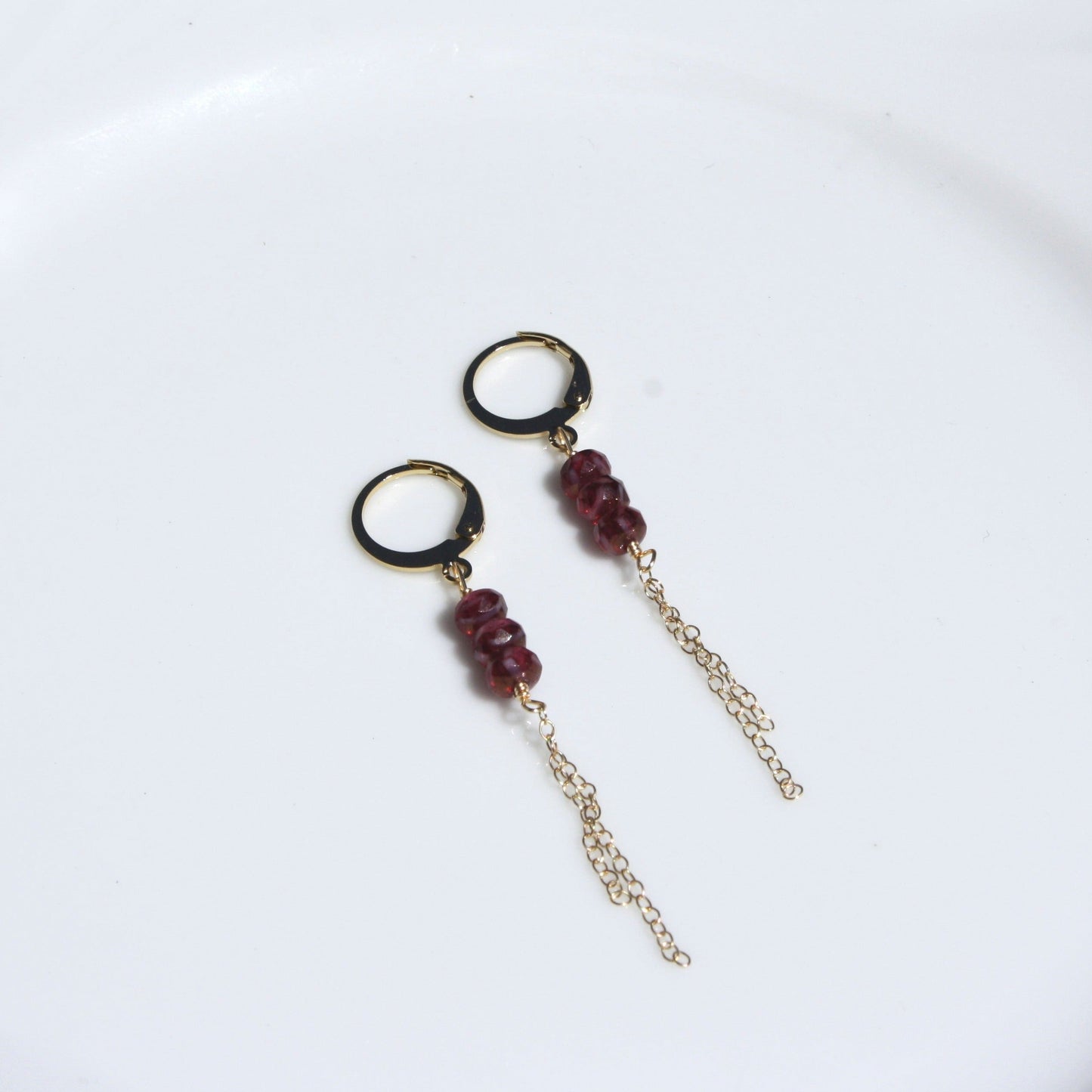 Gold huggie dangle earrings in ruby.