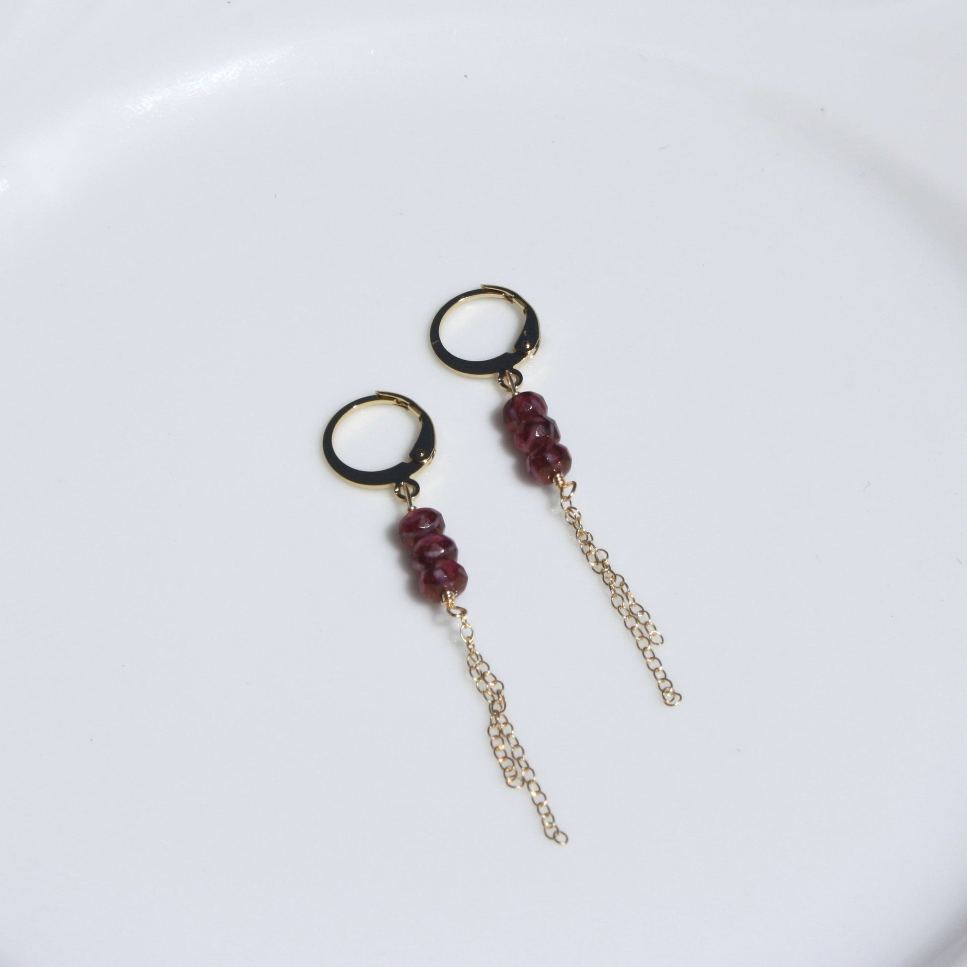 Photo of ruby huggie earrings.