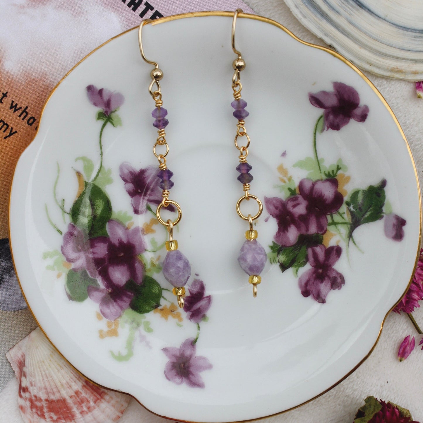 Purple HazeMaterial info: Gemstone dangle earrings Gemstone beads: Amethyst Tiny Faceted Saucer 3x4mm, Lepidolite Faceted Rice 8x6.5-7mm Wire: Tarnish resistant. 22-gauge gold copper Jump rings: 18k gold plated Lepidolite properties: "peace stone" or "gra