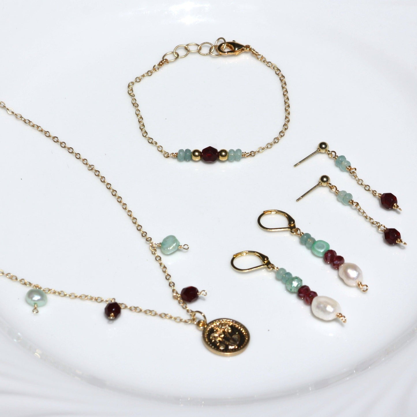 Jewelry set with necklace, bracelet, and earring stack.