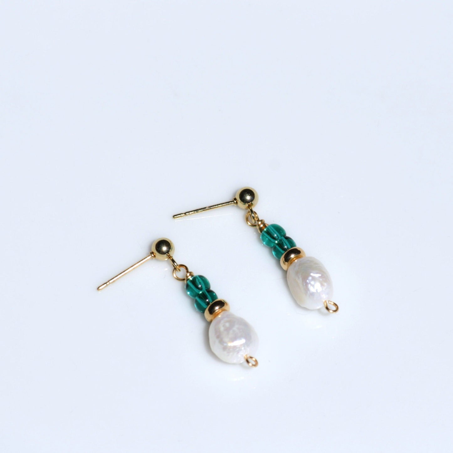 Simple pearl earrings with ball post findings and teal seed beads.