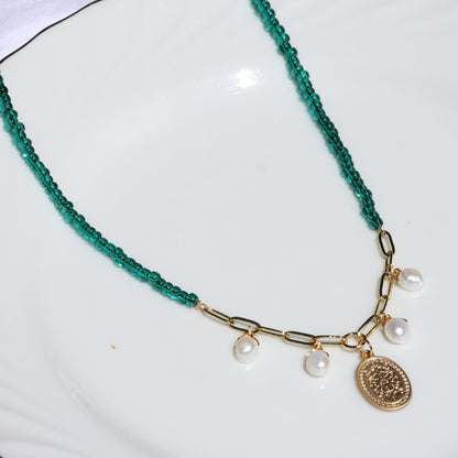 Teal seed beaded necklace with white dangle pearls and gold charm.